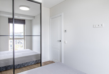 Modern Home Bedroom with Simple Design and Large Mirrored Closet