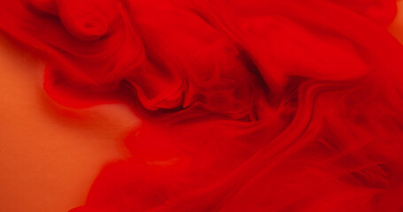 Paint background. Color smoke. Blur red crimson water fog chemical pigment wave wet texture fluid swirling on orange art abstraction.