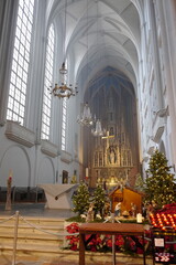 Serene Interior of a Church with Festive Decorations and Glowing Christmas Trees Illuminating the...
