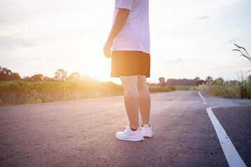 Fototapeta premium young man runner running on running road in city park