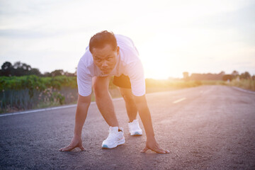 Fototapeta premium young man runner running on running road in city park