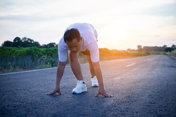 Fototapeta premium young man runner running on running road in city park