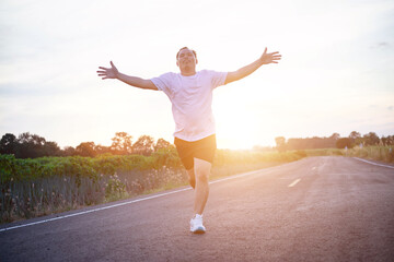 Fototapeta premium young man runner running on running road in city park