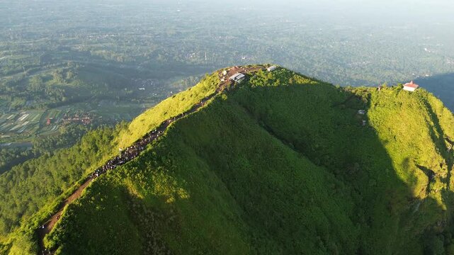 aerial view of green mountains with hiking trails on Mount Andong, Central Java, Indonesia