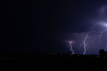 bright lightning in the night sky over the city