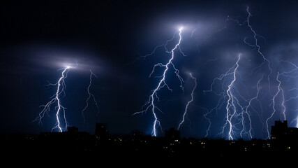 bright lightning in the night sky over the city