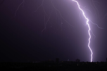 bright lightning in the night sky over the city