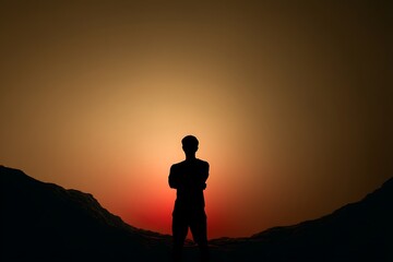 Fototapeta premium Solitary Silhouette of a Man at Sunset, Contemplating the Majestic Mountains