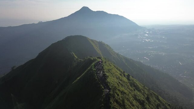 aerial view of green mountains with hiking trails on Mount Andong, Central Java, Indonesia