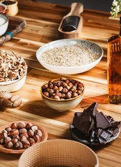 A curated arrangement of classic baking ingredients for Easter cozonac, featuring flour, sugar, chocolate, and nuts, all set against a warm wooden backdrop to inspire time-honored family traditions