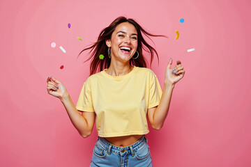 A radiant young woman in her 20s bursts with joy against a bright pink backdrop
