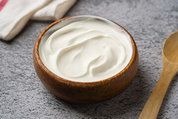 Top view of yogurt in bowl on grey stone table. Healthy eating concept