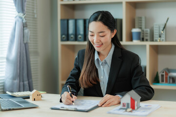 A business agent discusses property or financial plans with a client, highlighting trust, protection, and family security through symbols like keys, contracts, and unity.