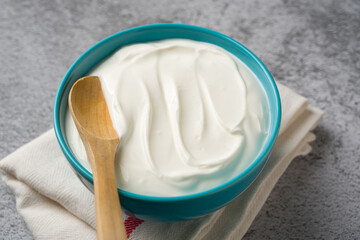 Top view of yogurt in bowl on grey stone table. Healthy eating concept
