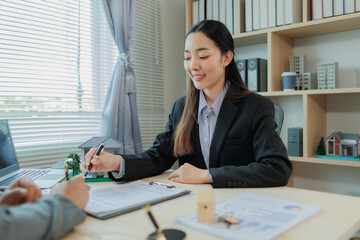 Signing a contract, handing over payment, and receiving the key to finalize a home sale — a key...