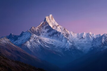 Snowy mountain peak at dawn with a soft pink sky