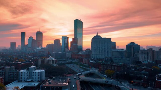 Amazing pink sky over the city at dusk time. Aerial perspective on modern Boston, Massachusetts, USA.