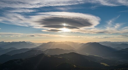 Fototapeta premium Sun Rays Breaking Through Lenticular Clouds Over Mountain Landscape