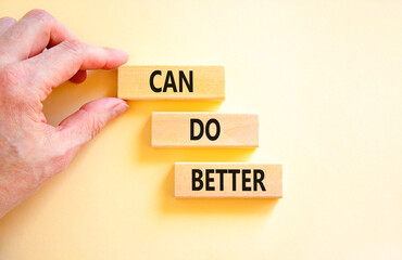 Can do better symbol. Concept words Can do better on beautiful wooden block. Businessman's hand. Beautiful white background. Business and can do better concept. Copy space.