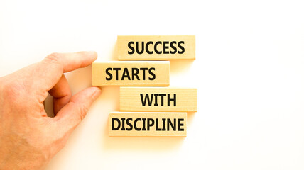Success starts with discipline symbol. Concept words Success starts with discipline on beautiful wooden blocks. Beautiful white background. Business success starts with discipline concept. Copy space