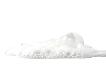 Closeup of a single iridescent soap bubble nestled in a pile of fluffy white foam