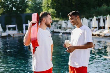 Lifeguards relaxing by the pool during break time