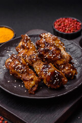 Grilled chicken wings in teriyaki sauce. Hot spicy takeaway food