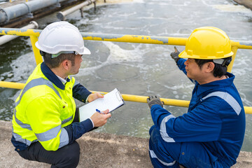 Environmental engineers work at wastewater treatment plants,Water supply engineering working at Water recycling plant for reuse,Technicians and engineers discuss work together.