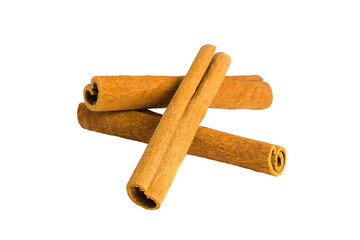 Cinnamon bark shards arranged on a white surface, highlighting their fibrous texture and rich brown hues.