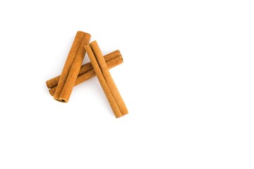 Assorted cinnamon bark pieces displayed on a white background, showcasing their unique shapes and textures.