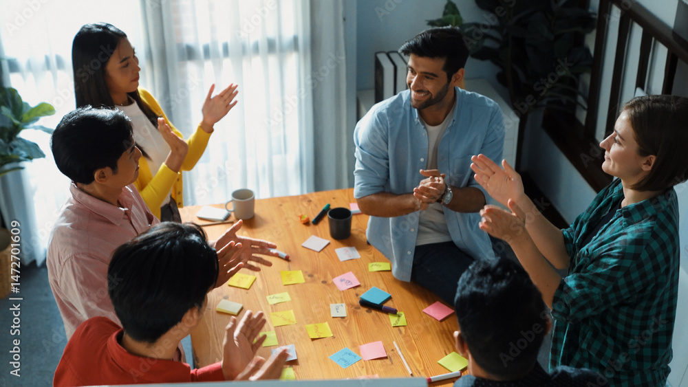 Poster top down view of business team clapping hands to celebrate successful idea while standing at meeting