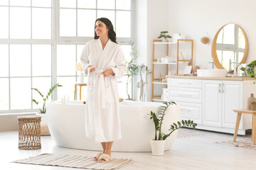Beautiful young happy woman in bathroom