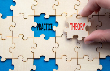 Fototapeta premium Theory or Practice symbol. Concept word Theory or Practice on wooden puzzle. Businessman hand. Beautiful blue background. Business and Theory or Practice concept. Copy space