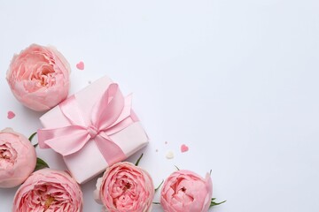 Beautiful pink peony roses gift box on white background, space for text