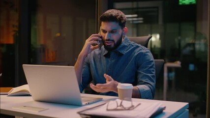 Businessman Indian guy multitasking business man male in night late office overtime work talking mobile phone call discuss computer laptop commerce smartphone conversation smiling manager consulting - Powered by Adobe