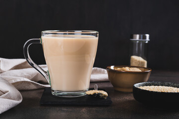 Tahini latte with sesame spread in a cup on the table