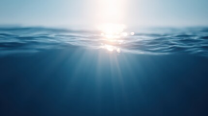 Obraz premium Calm ocean surface, bright sunlight reflecting on tranquil water, serene blue tones, ideal for relaxation or nature themes.