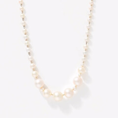 A delicate white pearl necklace with gold accents, exuding elegance and sophistication.