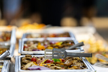 Colorful buffet spread featuring assorted dishes and fresh ingredients at a festive outdoor event