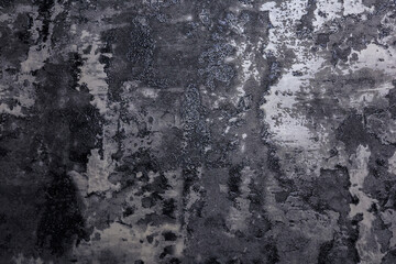 Close-up of a rugged concrete texture wall in grayscale with natural wear, water stains, and...