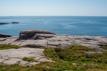 coastal landscape with expansive ocean view and rocky shoreline.