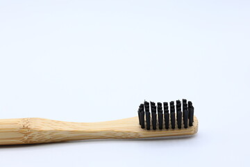 Black and wooden toothbrush. Ecological concept.