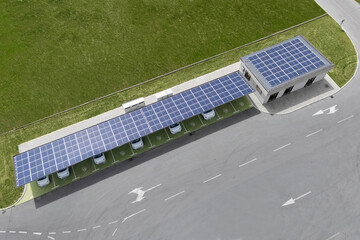 Electric car charging station that takes energy from solar panels. Solar canopy aerial view