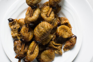 Overhead view of roasted sago worms, top view of palm worms, roasted grub worms on white background