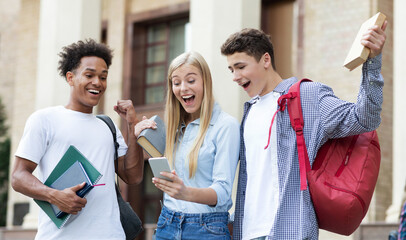 Excellent marks. Surprised students checking exam results online on smartphone