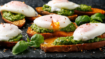 Sweet potato toast with green pesto and egg Benedict. Vegetarian protein food concept