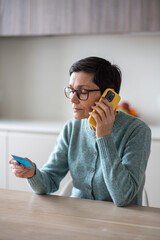 Plakat Calm naive senior female dictates debit credit card digits and CVV code during fraudulent phone request. Payment data theft, account takeover, elder financial abuse, urgent bank notification need