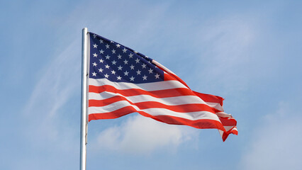 American flag of United States of America over blue sky
