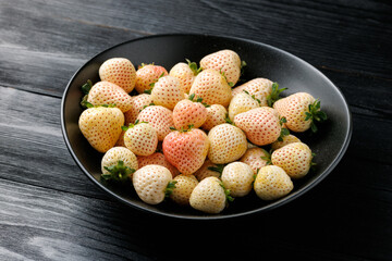 Organic Raw Pink Pineberries Strawberry in a bowl. Healthy food