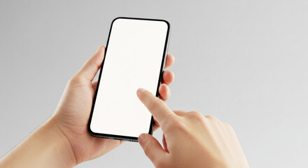 Hand using smartphone touchscreen against gray background  